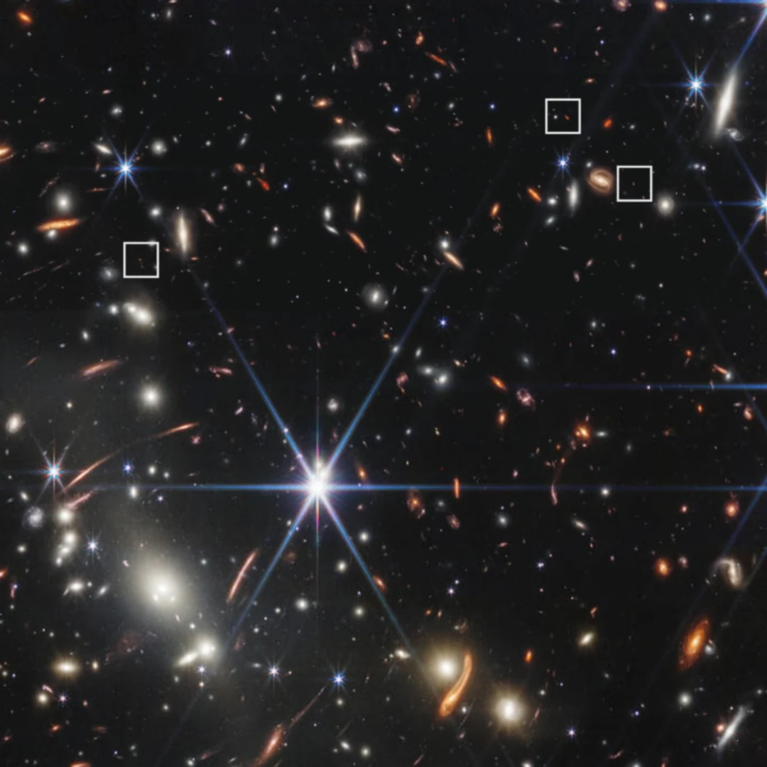 Webb deep field image of galaxy cluster SMACS 0723 showing thousands of orange and white galaxies with three highlighted early-universe objects