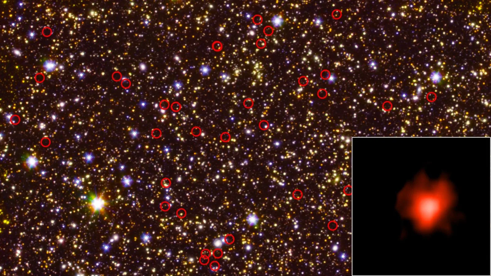 A deep-field view of the sky captured by NASA's Spitzer Space Telescope showing hundreds of faint distant galaxies scattered across the frame