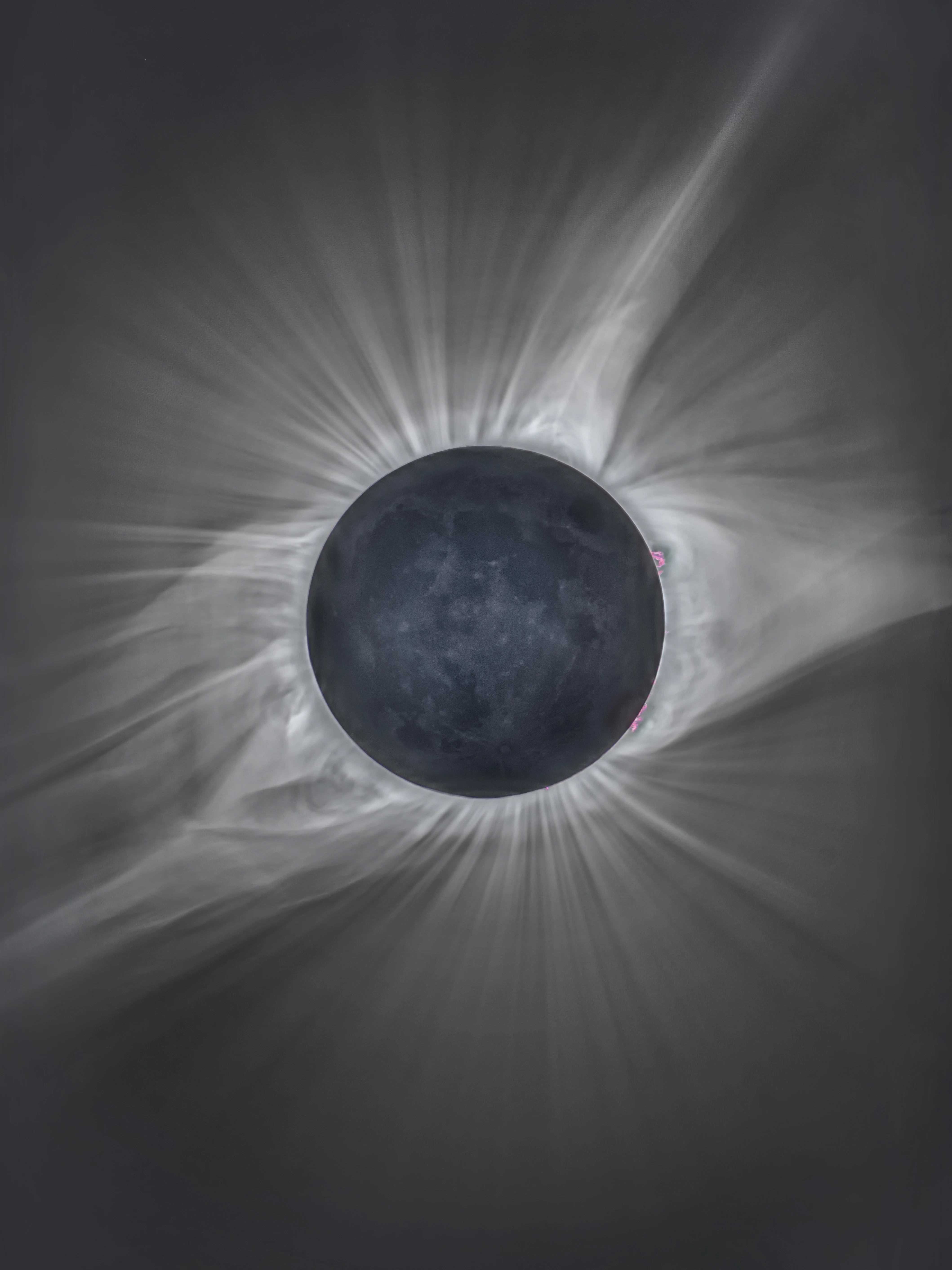 Total solar eclipse showing the Sun's corona radiating outward from behind the Moon's dark silhouette