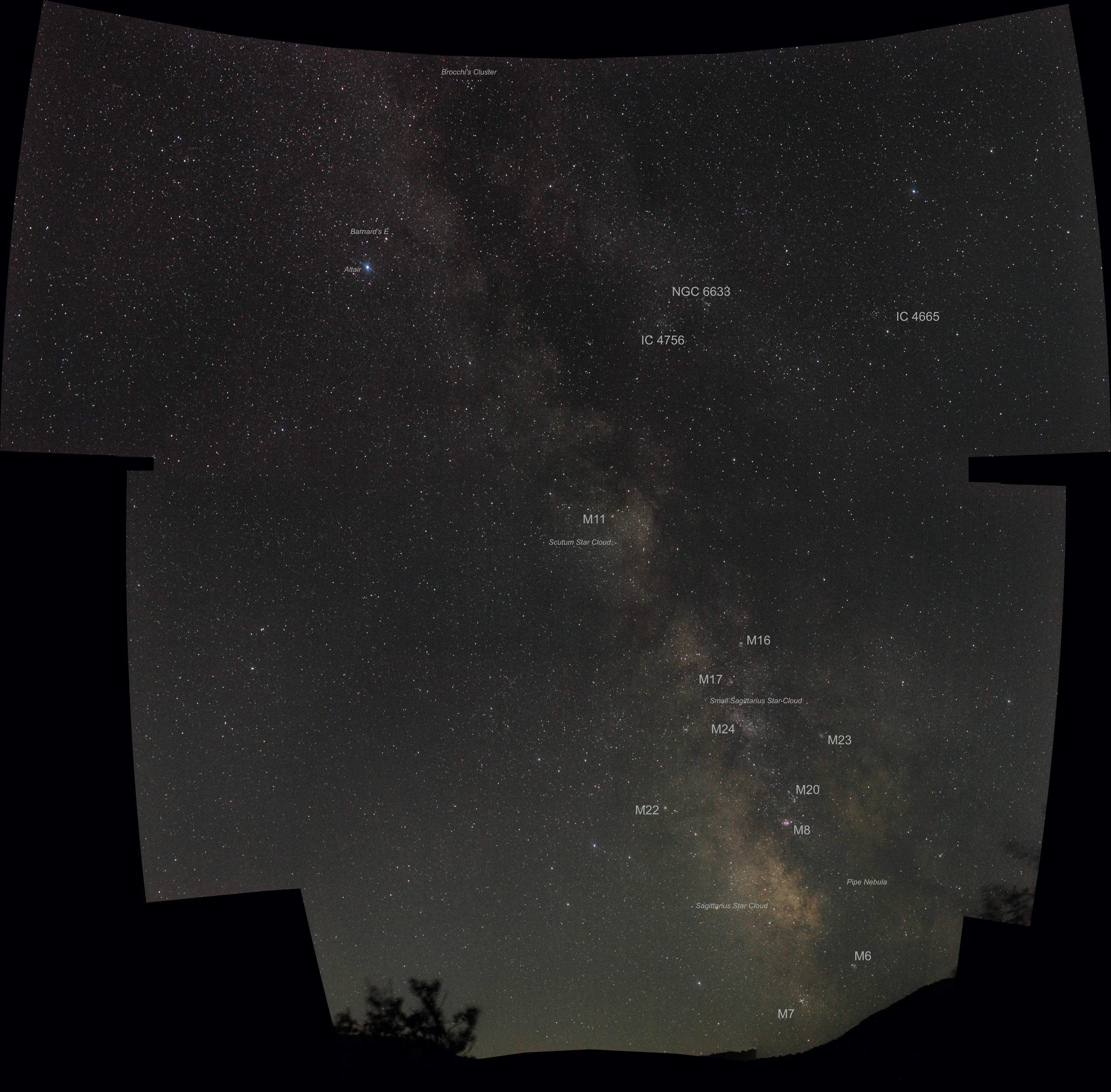 Wide-field photo of the summer Milky Way stretching from Vulpecula down to Scorpius, its bright star clouds crowding toward the galactic center low in the sky