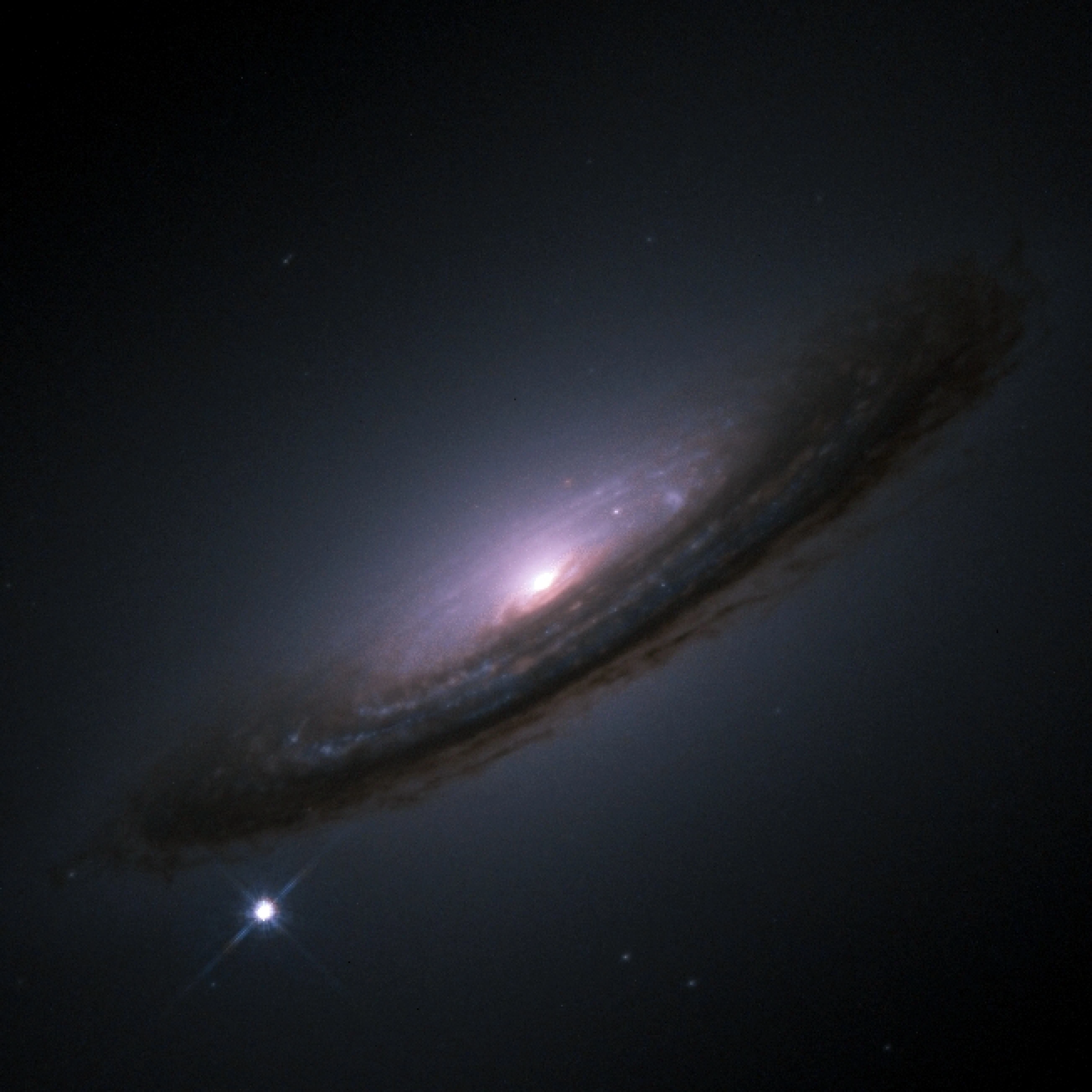 The Hubble Space Telescope image of Type Ia supernova SN 1994D, a bright point at the lower-left edge of the galaxy NGC 4526, shown to illustrate how a single exploding star can rival its host galaxy in brightness.