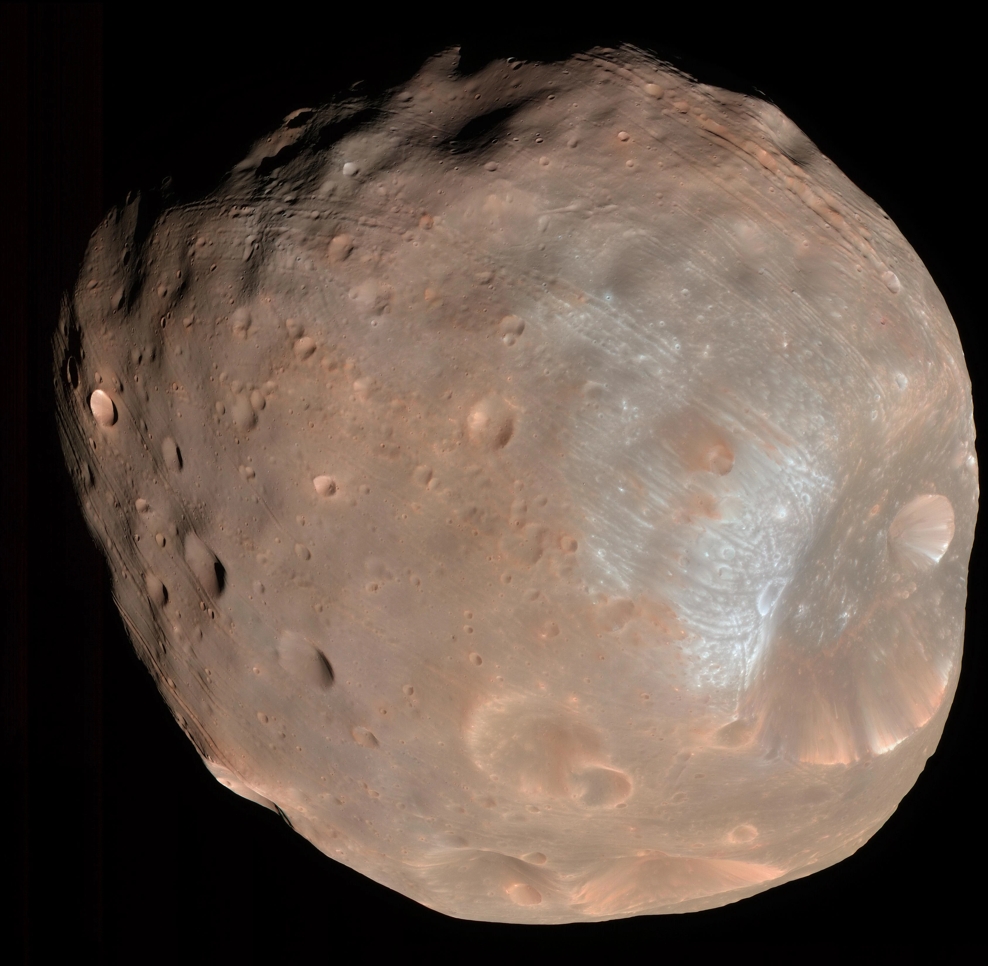 Colour image of Phobos from NASA's HiRISE camera: a dark, lumpy, cratered moon with grooves across its surface and the large crater Stickney at lower right